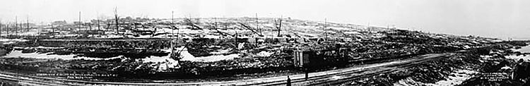 Panoramic view over traintracks to destroyed cityscape